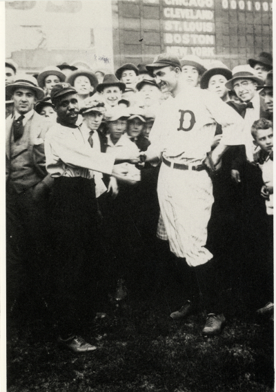 Ty Cobb shaking hands with a fan