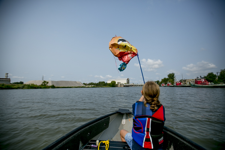 Jessica Spiess plays with a balloon she fished out of the water