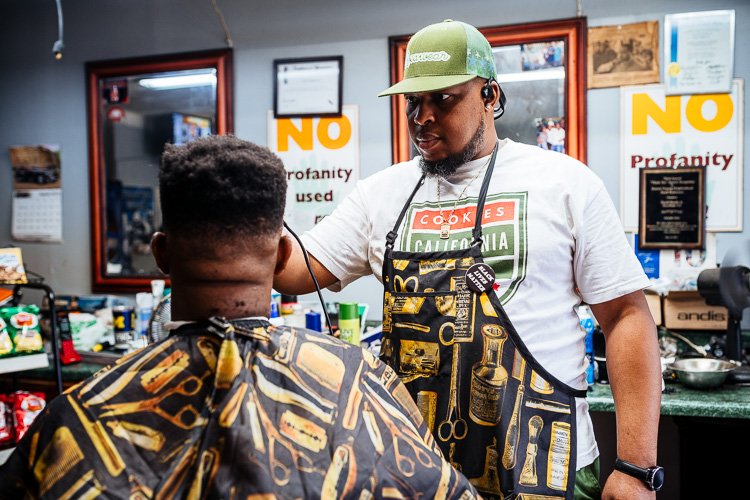 Hardin Jr. cuts a customers' hair