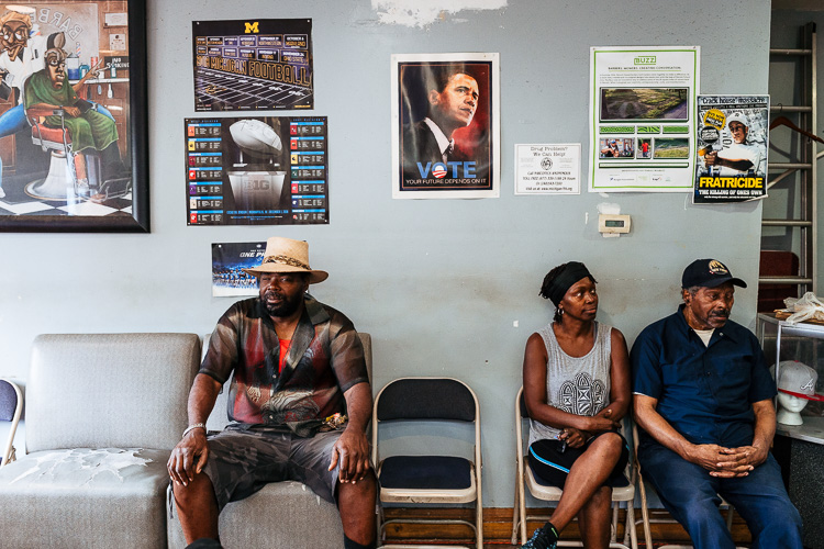 Customers wait for their hair to be cut