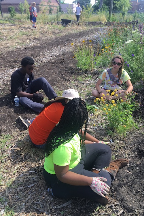 Hanna Fine gardening with other volunteers