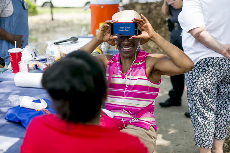 Residents play charades at a community cookout