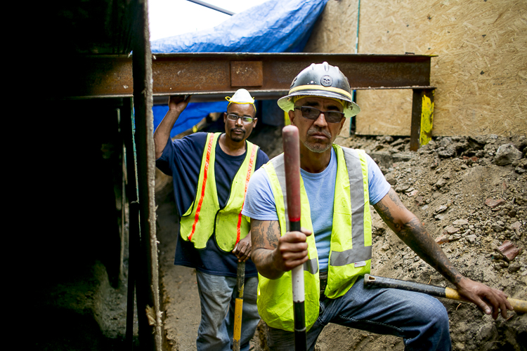 Jerone Martin and Dave Jimenez of AGI Construction in a trench dug to replace part of the foundation for Detroit Future Ops