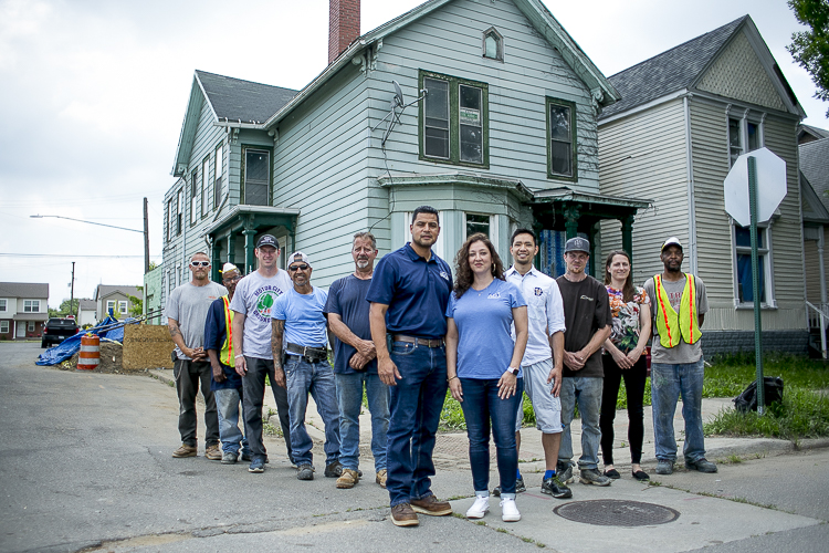 Ali and Saldivar-Ali with the crew of AGI Construction outside the future community resource center