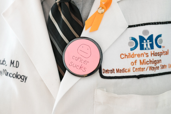 "Cancer sucks" pin on Dr. Taub's lapel