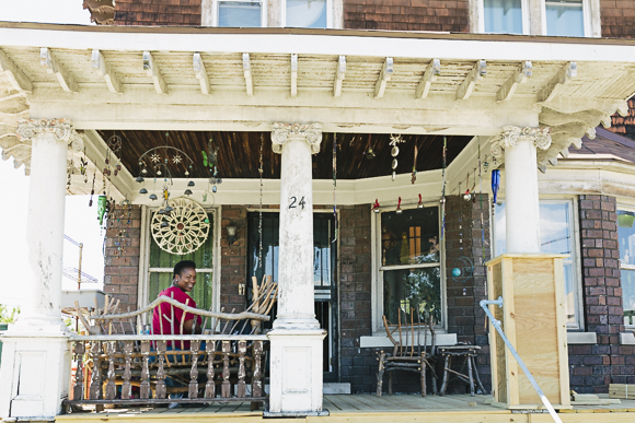 Mama Shu on the porch of the first house she purchased in Avalon Village for $3,000.
