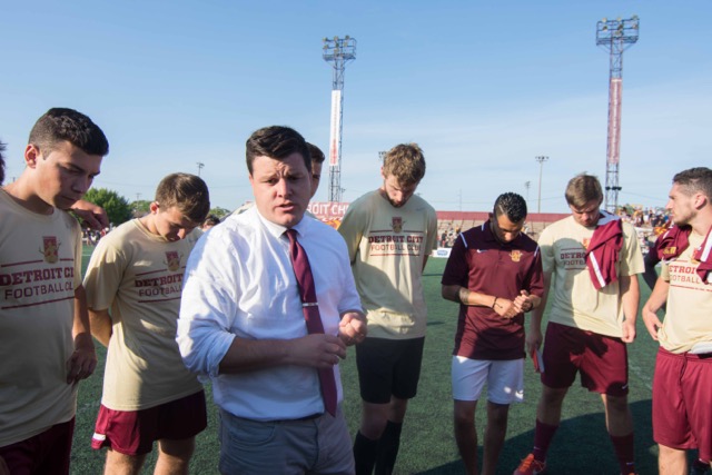 Coach Ben Pirmann huddles with this players