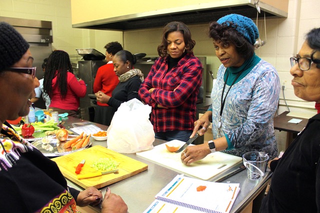 Nefer-Ra (in blue) holds court and chops onions