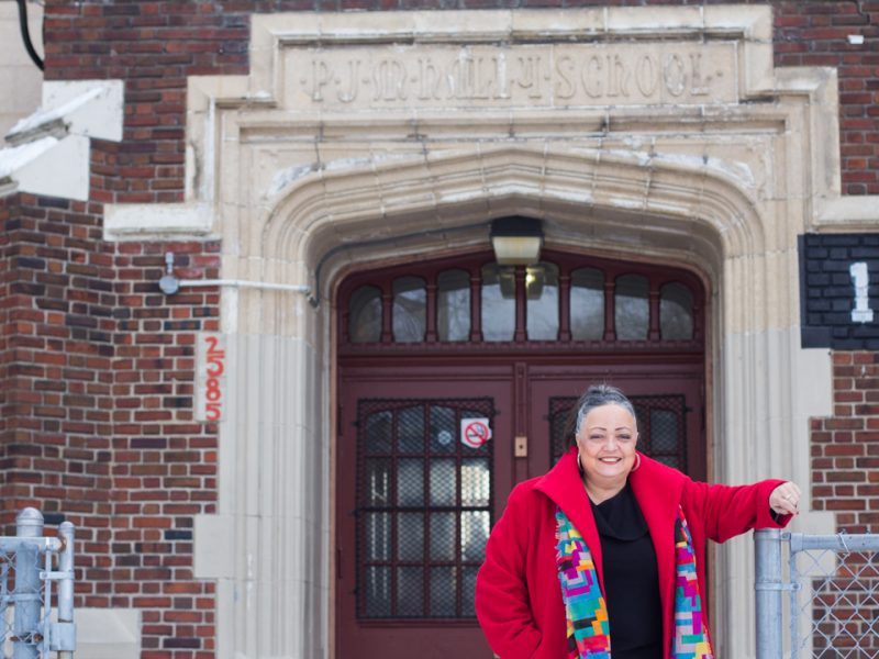 Kearny in front of her old school, now the Paul Robeson/Malcolm X Academy