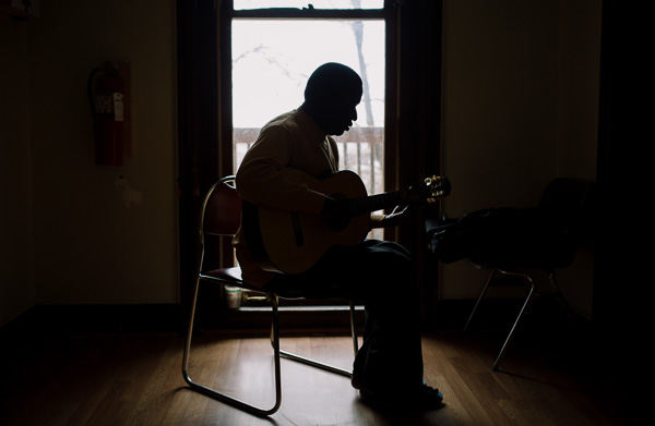 Resident plays guitar