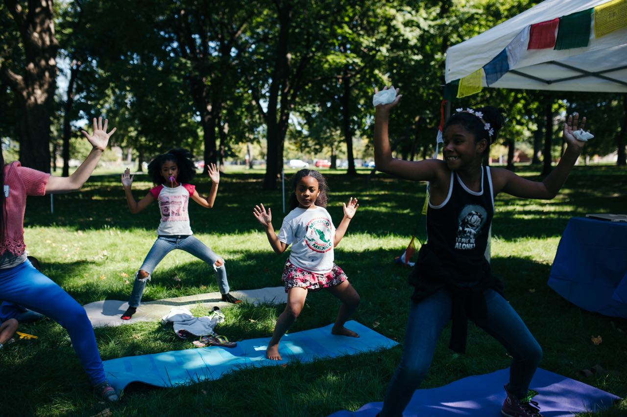 Kids do yoga in the park