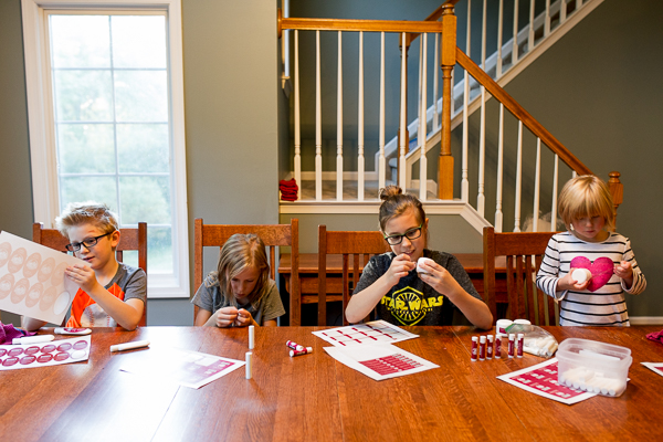 Anderson, Glory, Hudson, and Victory Guilmette help with their mother's business