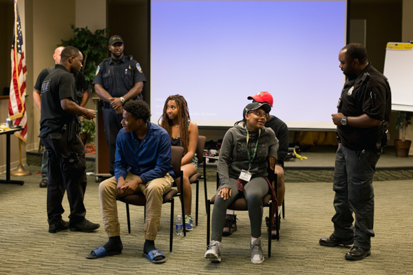 Wayne State officers roleplay a traffic stop with participants in the peace and conflict studies workshop