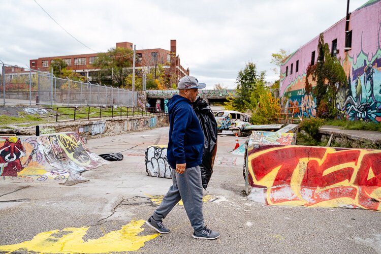 Will Smith, Rockwell's partner on Filthy Americans, picks up trash as part of a neighborhood cleanup in October.