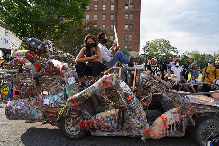 Zora Bowens rides Carcroach in Detroit to protest the deaths of George Floyd and Breonna Taylor. The roach car was made by local artist Ryan Doyle. Courtesy photo.