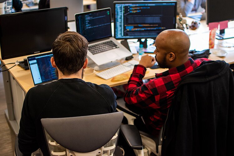 Developers at Detroit Labs work on a project.