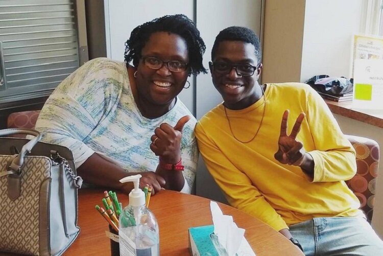 Shammah Sharp with his mother at the Community Music School in Detroit.