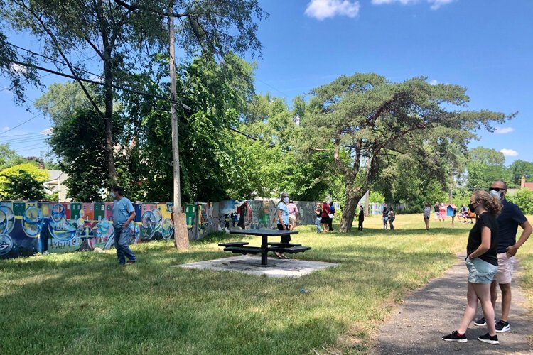 Participants take in the Birwood Wall during a tour in June.
