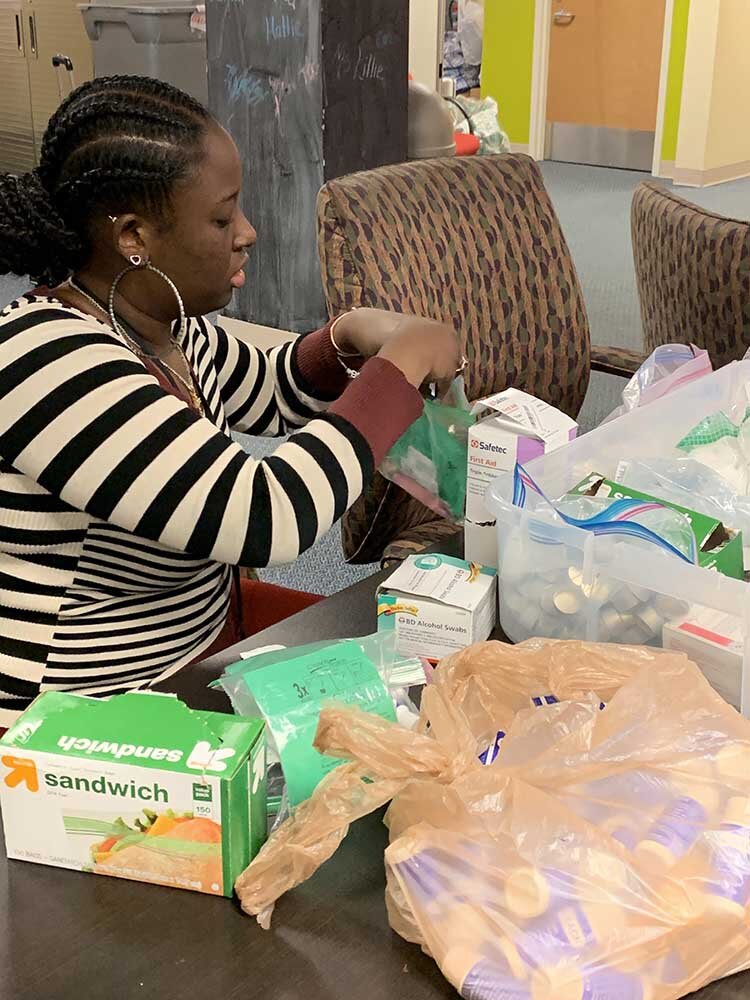 Alternatives for Girls employees packing kits for AFG's Crisis Resource Center for distribution on the streets and for walk-ins.
