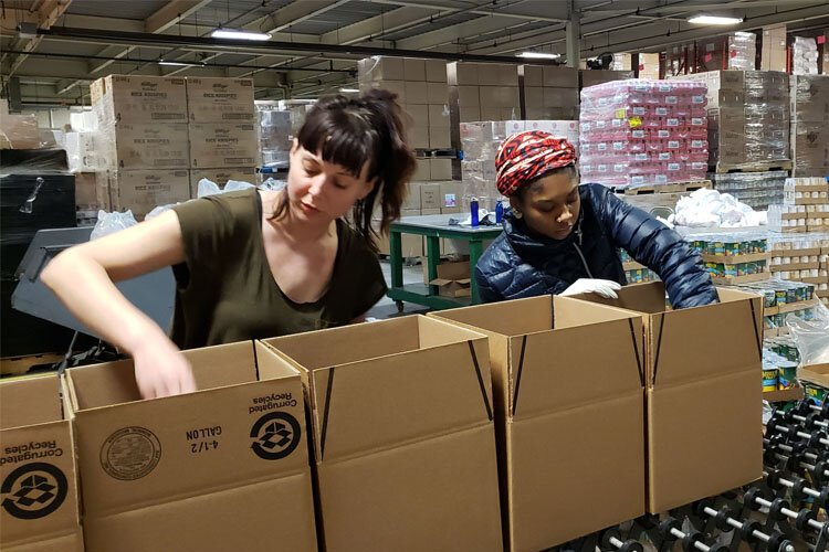 Gleaners Community Food Bank works pack food boxes at the Detroit warehouse.