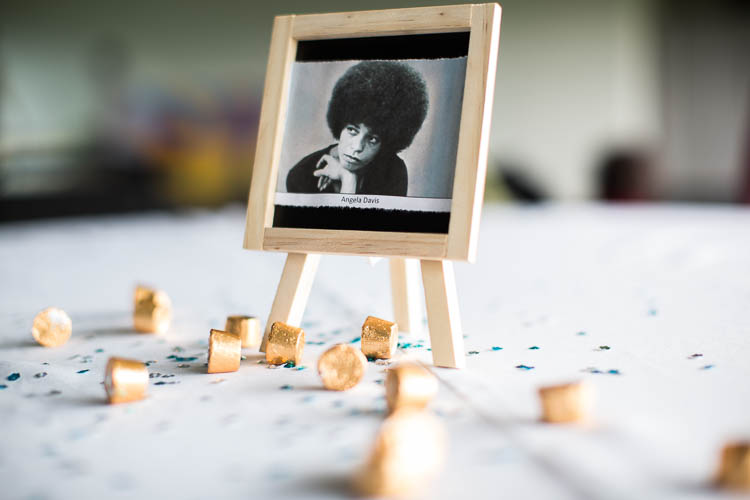 Festive tables were labeled with the names of prominent social activists such as Angela Davis. Photo by Nina Ignaczak.