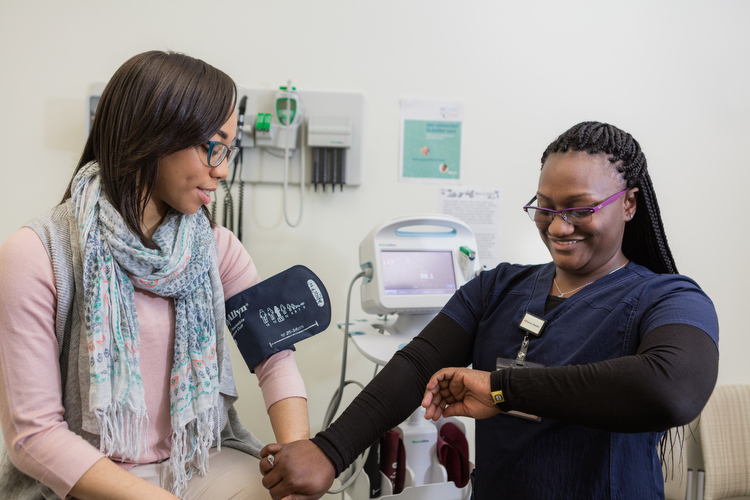 A member of Cherry Health's integrated care team takes a blood pressure reading.