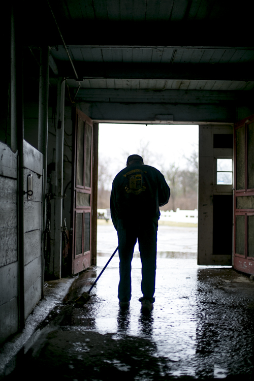 James Mills clears a puddle from the BHSA barn.