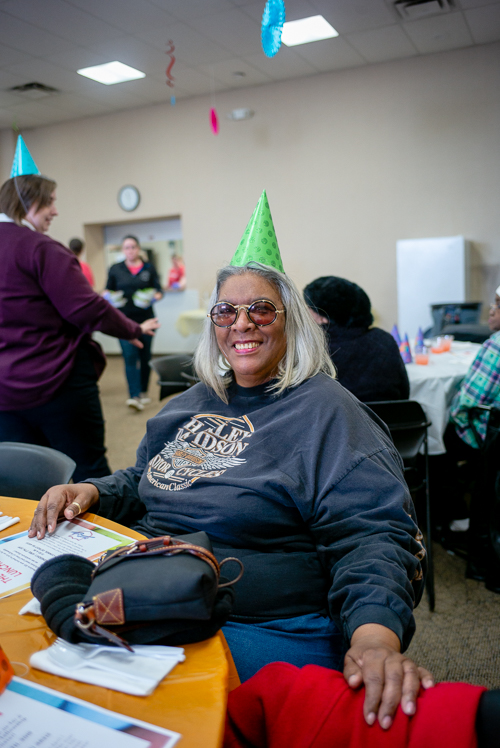 A participant at the Salvation Army's monthly senior luncheon dons a festive hat. 