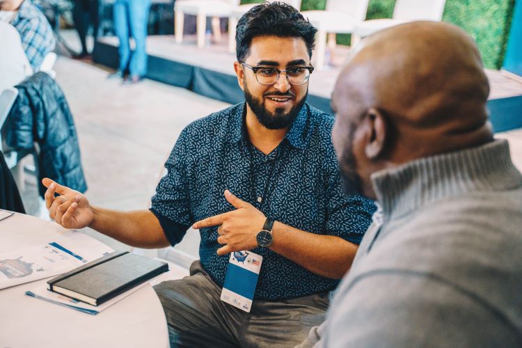 Two Detroiters engage in a conversation during the Better Arguments event.