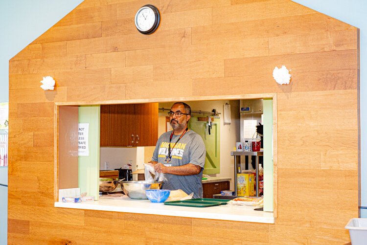 Chris Elliott at the Edison YWCA opens the doors to the kitchen so that children can see the food being prepared.