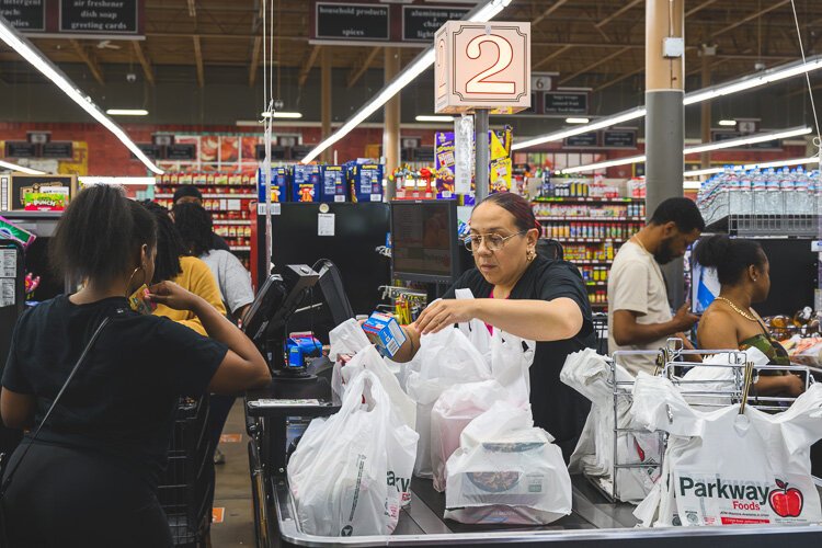 Nia Morris rings up customers at Parkway Foods.