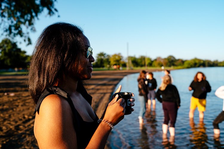 Cambrey Thomas holds her coffee mug while looking out at the river.