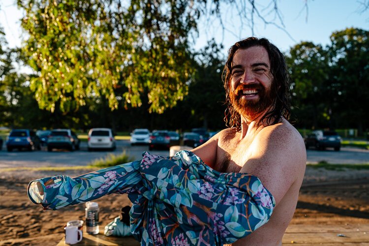 Chuck McKeever puts a shirt back on after drying off.