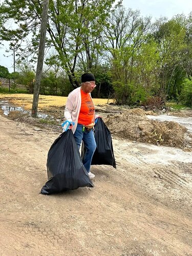 Volunteer participates in CRCAA community cleanup. (Photo courtesy of CRCAA)