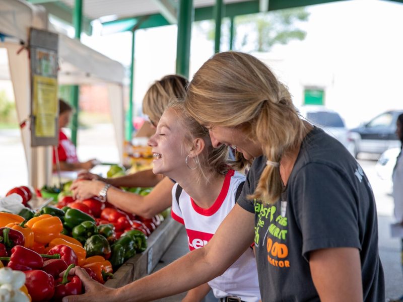A Farmers Market Food Navigator assists shoppers at the Muskegon Farmers Market.