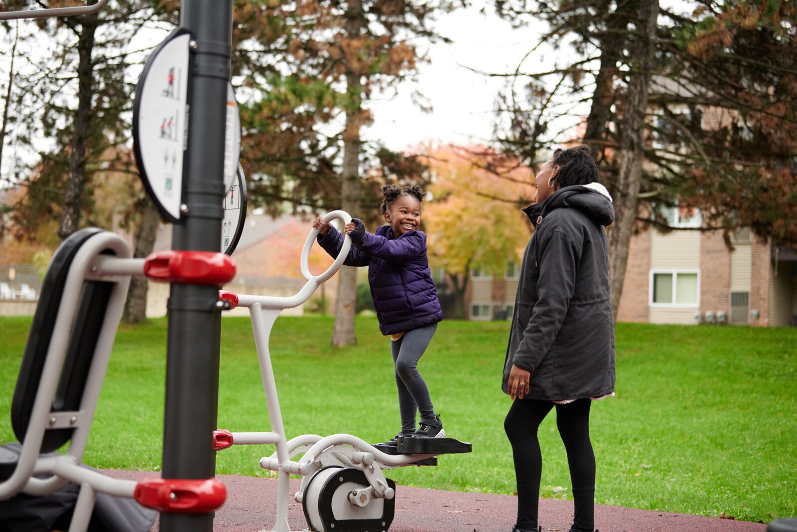 People play at the Fitlot outdoor fitness park at Rotary Park in Lansing.
