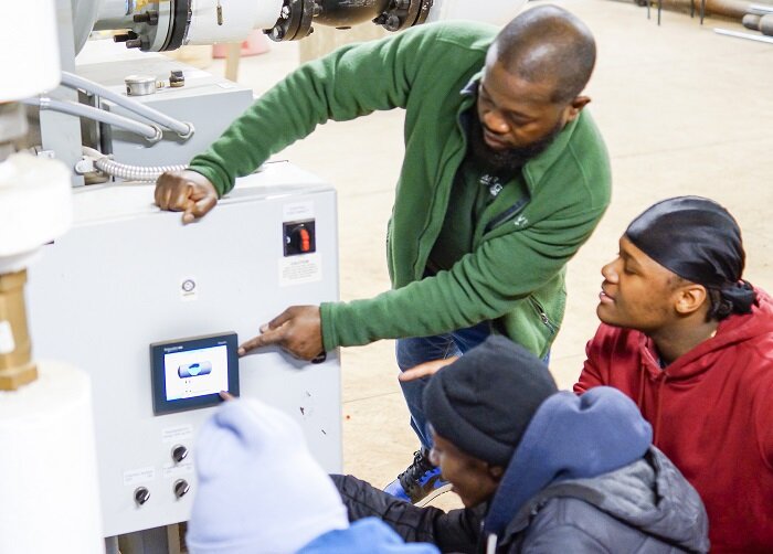 Building Engineer Kirk Johnson guides students through HVAC safety system evaluations. Photo: Supplied / Naomi Tajonera, TSM