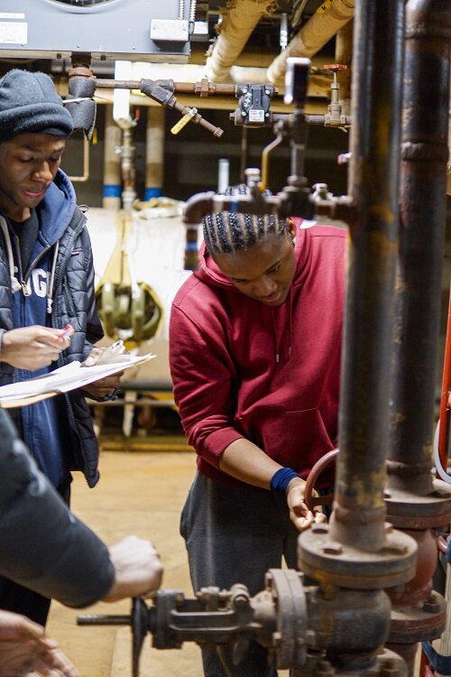Students learn about operations for existing and newly installed state-of-the-art HVAC systems on the Marygrove campus. Photo: Supplied / Naomi Tajonera, TSM