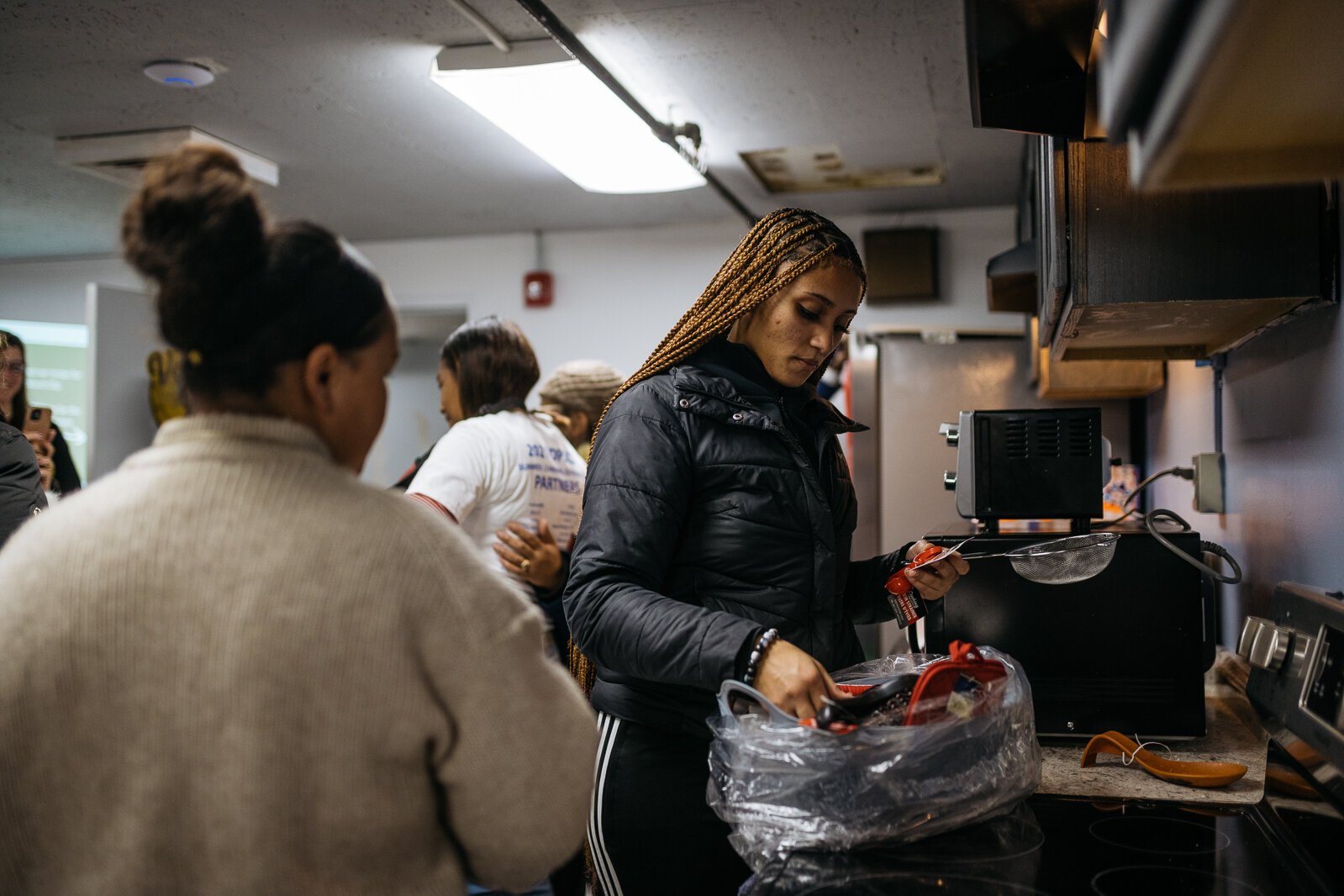 A TAC member checks out cooking utensils at the opening of the Vault's new kitchen. (Steve Koss)