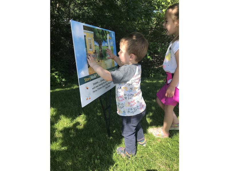 Children enjoy a StoryWalk®.