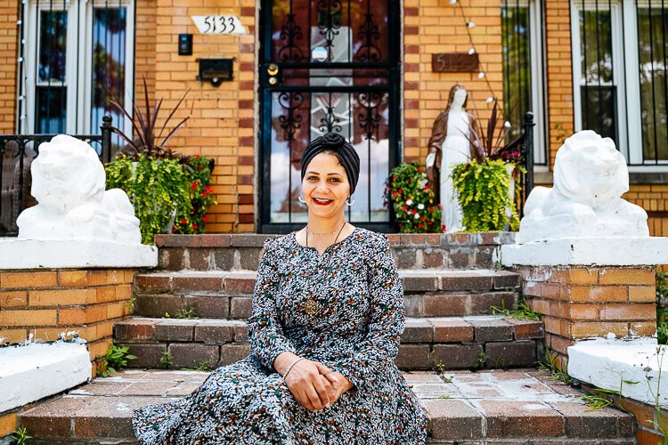 Fadiah Yahya sits in front of her Southwest Detroit Home.