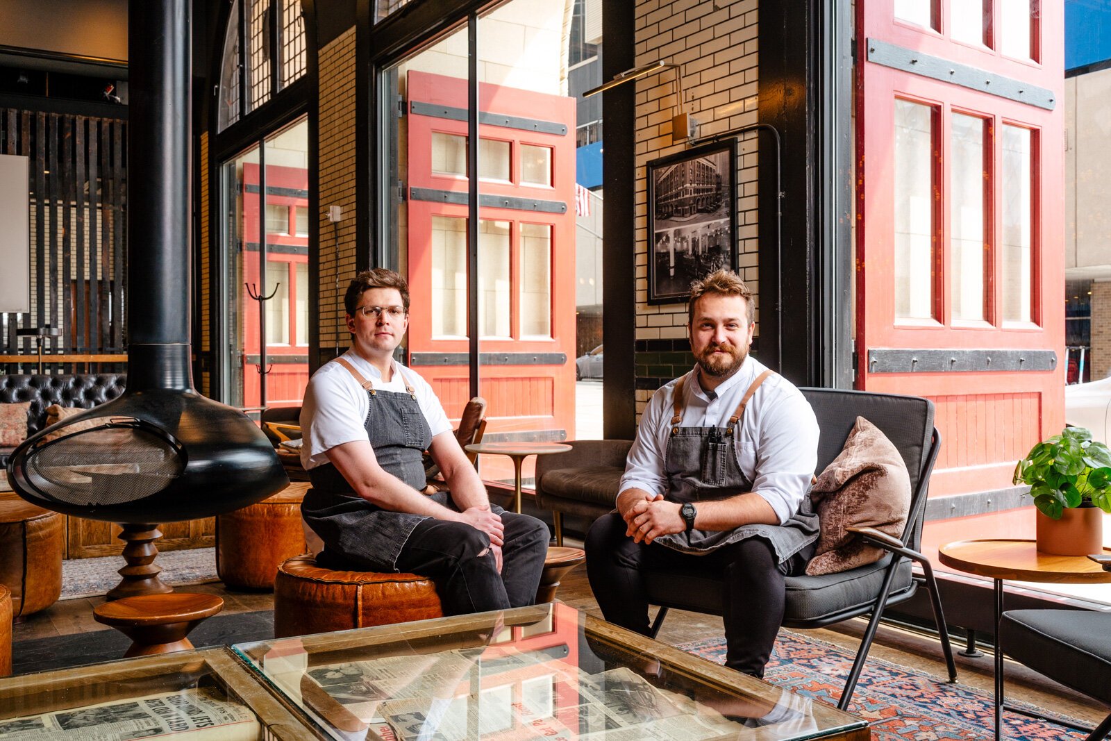 Duncan Spangler and Ken Miller pose in the lounge area of the Apparatus Room.