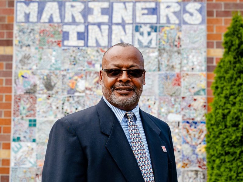 David Sampson, CEO of Mariners Inn, stands in front of a building that is part of a redevelopment project that will enable his organization to provide seamless transitions to affordable housing for the clients served.