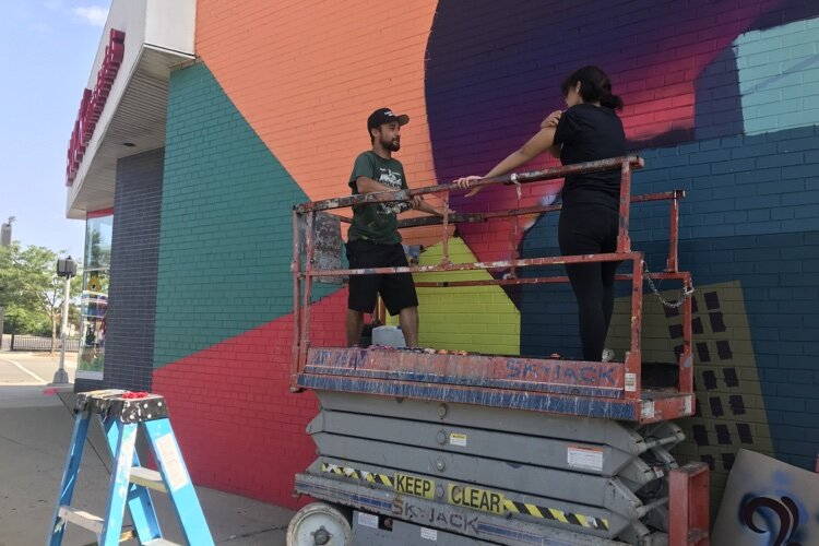 Professional muralist Zach Curtis helped guide students through the process.