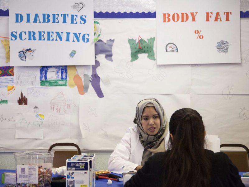 Begum screens a patient for diabetes. Courtesy photo.
