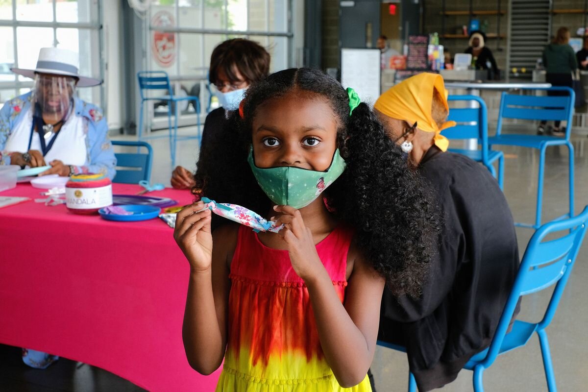 A young participant creates a healing pouch for the COVID-19 Healing Memorial.