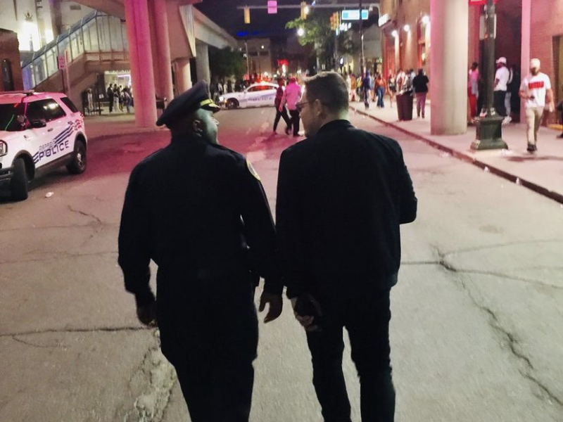 Commander Franklin Hayes walks with Adrian Tonon through downtown Detroit