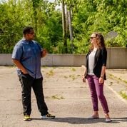 Jermaine Ruffin, at left, and Anna Shires, at right, discuss the bank's involvement in the city of Detroit during a visit to the East Warren neighborhood.
Photo by Nick Hagen