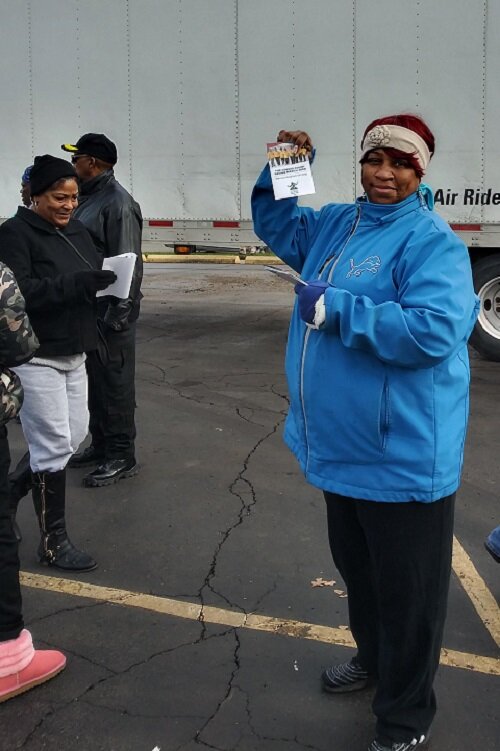 Cody Rouge CCA doing census outreach during a food giveaway.
