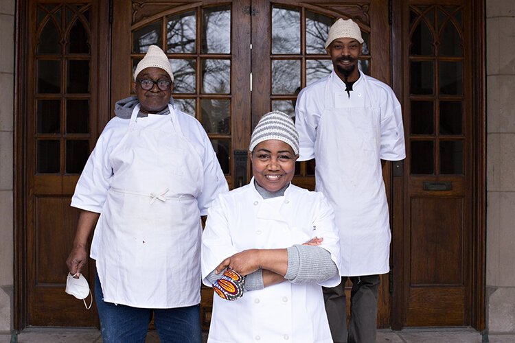 Arthur Mitchell (left) assists his sister Ruth Bell, and her son Robert Mitchell bake goods for Bell's business, Chugga's Bakery.